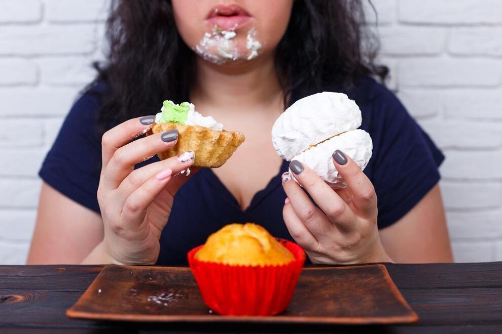overweight woman eats sweets